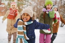 Diverse kids playing in snow smiling_small