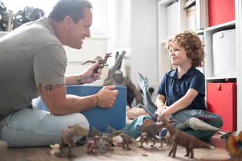 Father son playing with animals