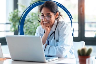 Female-Physician-with-Glasses-Smiling-at-Laptop-Blue-Brushstroke