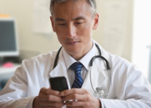 Doctor using Technology and Cell Phone Doctor using Technology and Cell Phone