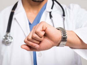 doctor looking at watch