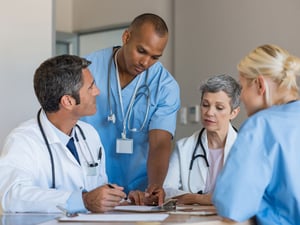 healthcare leaders talking at a table