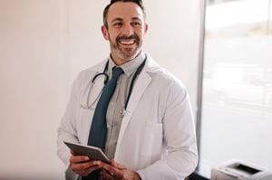 Male Physician with Tablet in Office