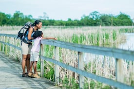 Mom and Daughter on Walk on bridge in marsh_small