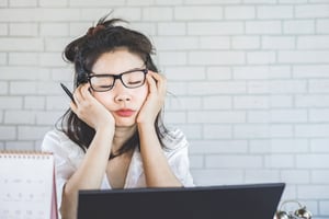 young woman exhausted at work