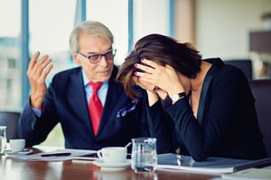 older businessman yelling and woman